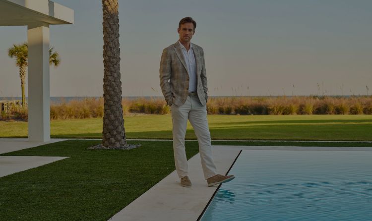 Two men wearing Peter Millar apparel. The man on the left is wearing Tailored Fit apparel, and the man on the right is wearing Classic Fit apparel.